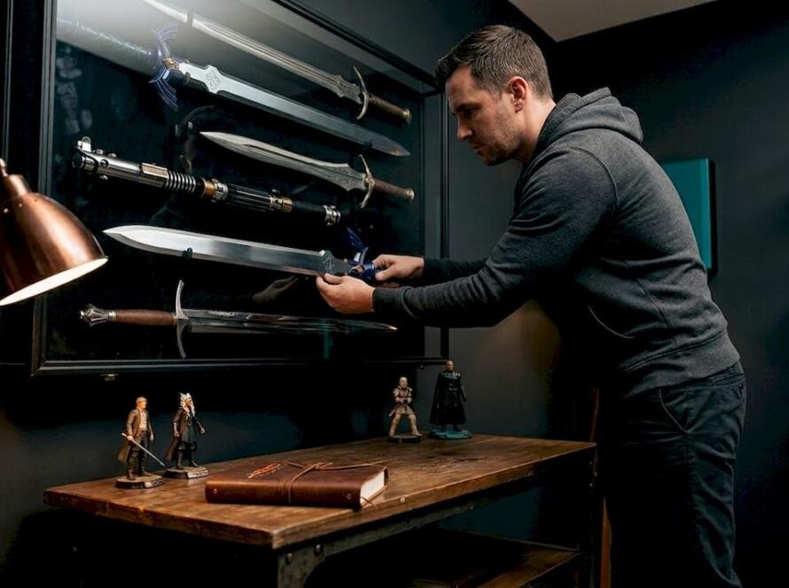 Collector organizing movie sword display case
