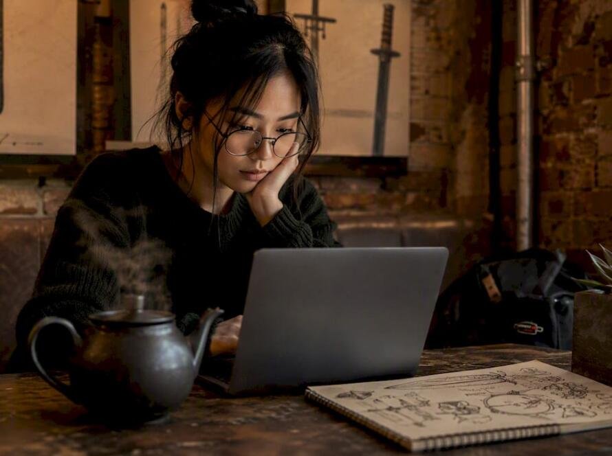Woman researching katana vendors online at table